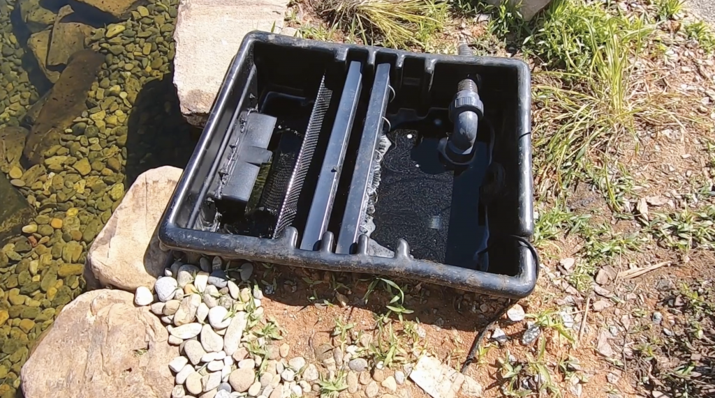 Skimmer installed into the side of a pond